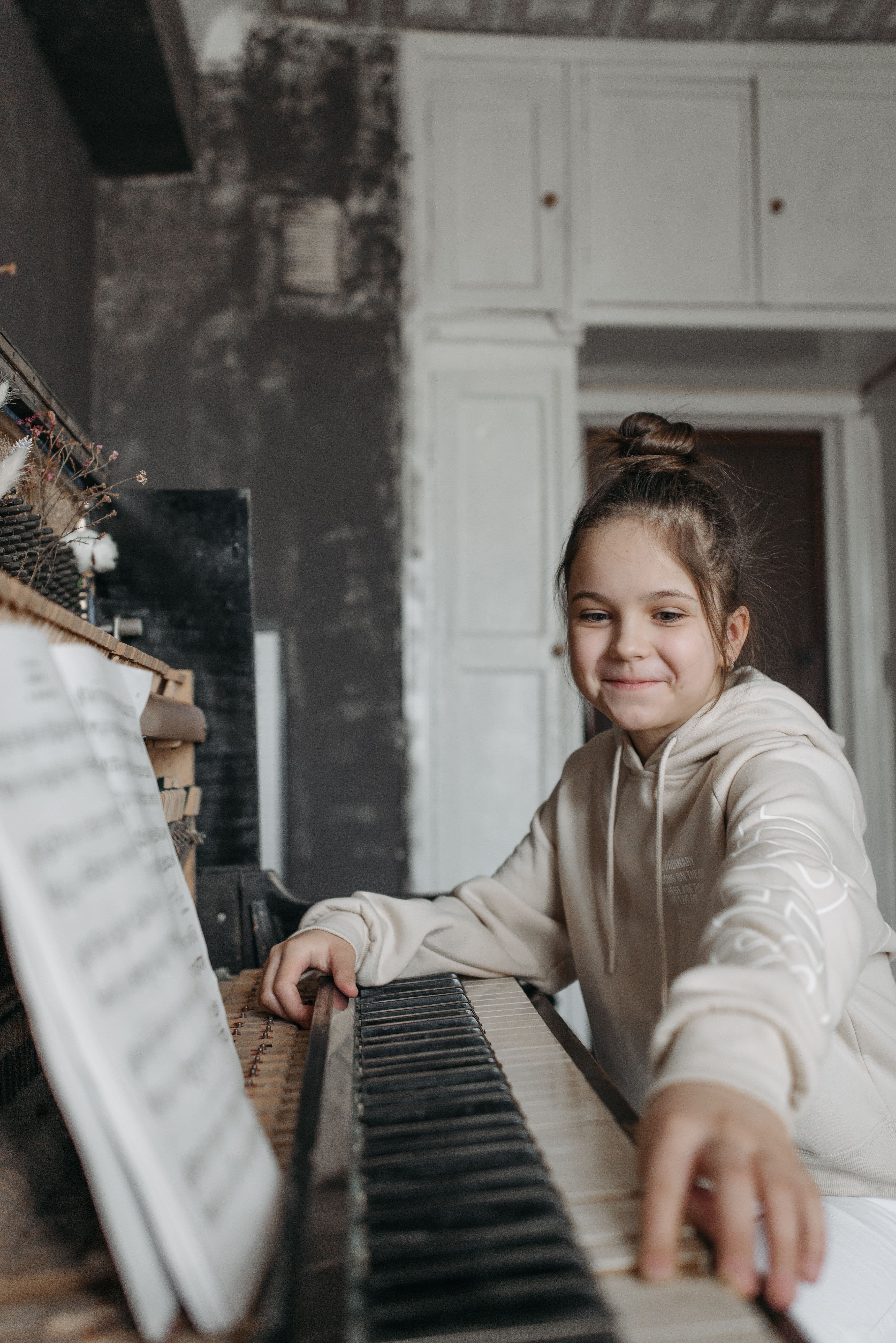 Young piano student smiling during a lesson
