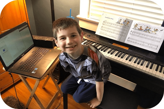 boy with keyboard and laptop